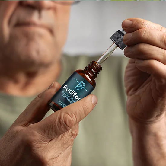 Adult holding an Audifort dropper bottle